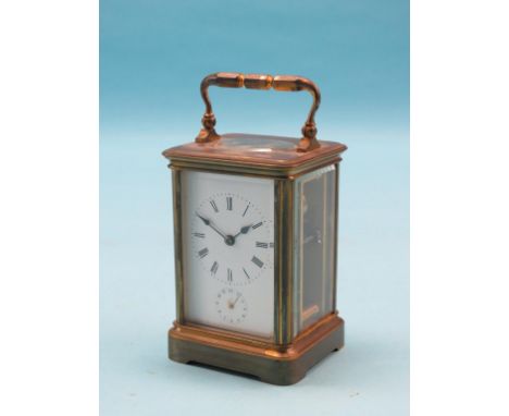 An early 20th century French brass carriage clock, enamelled dial with alarum, bell-striking movement, 6.5in.