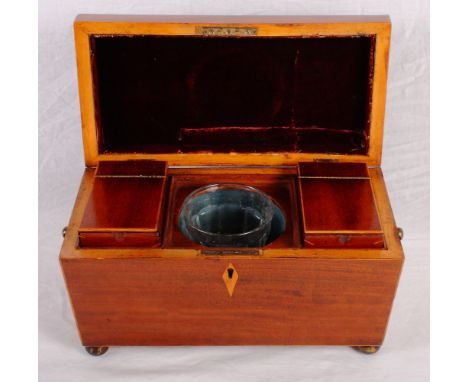 An early 19th Century sarcophagus-shaped two-compartment tea caddy with central mixing bowl, box inlaid edges, gilt metal rin
