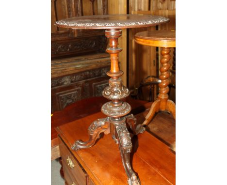 A Victorian circular stained wood occasional table with carved edge, on carved tripod base, 20" dia