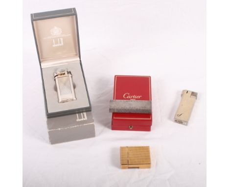 A boxed Cartier cigarette lighter, another by Dunhill and two others