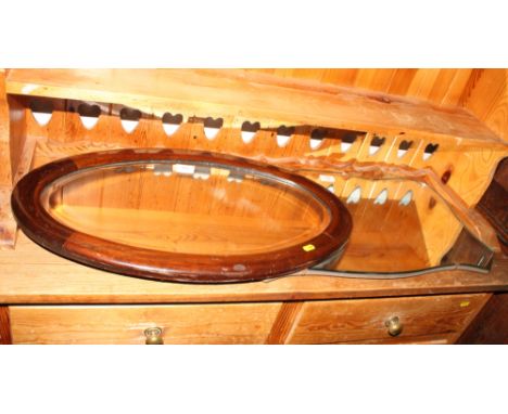 An Edwardian oval bevelled wall mirror in line inlaid mahogany frame, two similar smaller mirrors and a frameless mirror