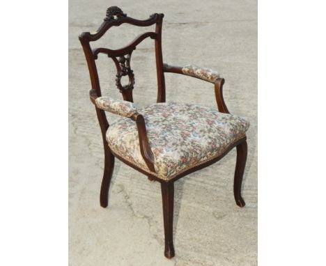 An early 20th Century open armchair with pierced splat, seat and arms upholstered in a floral tapestry