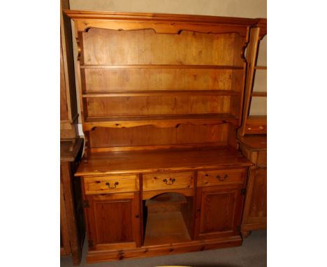 A mahogany three-tier open wall shelf, 28" wide, and a wall mirror in gilt scroll decorated frame