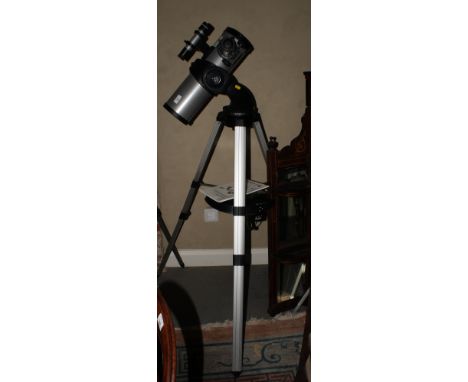 A Mead 114mm Newtonian reflector telescope on DS 2000 go to mount with two eye pieces and tripod