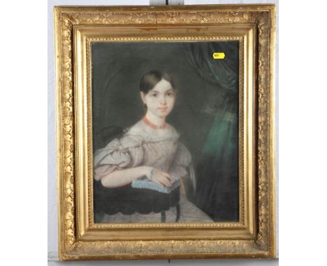 A 19th Century pastel, portrait of a young girl seated with her hand resting on a table, 16" x 13", in deep gilt frame moulde
