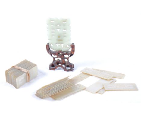 Two sets of engraved mother-of-pearl gaming counters and a carved and pierced jade panel on stand (panel repaired)