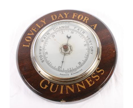 A Guinness advertising aneroid barometer, "Lovely Day for a Guinness", 8 1/2" dia