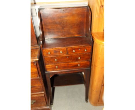 A Georgian mahogany bureau with recessed flap enclosing shelf, fitted two short and two long shallow drawers below, on square