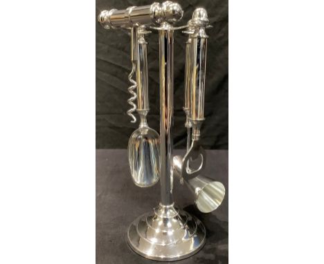 A plated drinks companion comprising corkscrew, measure, bottle opener and scoop on stand, 28cm high 