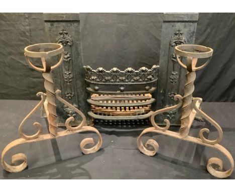 A 19th century cast iron fire grate; a pair of Arts and Crafts wrought iron fire dogs 