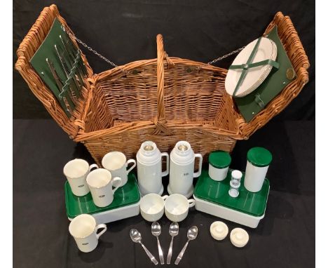 A Land Rover wicker picnic hamper, fully fitted, for four, comprising Berkshire plates and mugs, a pair of Thermos flasks, fl