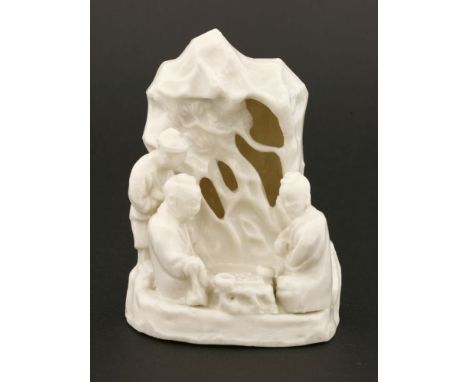 A Chinese blanc de Chine group,18th century, of two literati seated in front of pine trees and pierced rockwork playing go, a