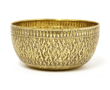 A silver gilt bowl,19th century, of circular form with flat base, the body decorated with stylised flames below a diamond and