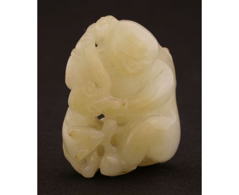 A Chinese jade carving,late Qing dynasty, of a boy seated with a lingzhi in his hands, a tree rat by his feet, the stone in a