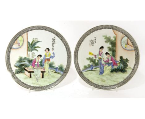 A pair of Chinese famille rose plates, early 20th century, each painted with ladies reading books or playing qin in a garden,