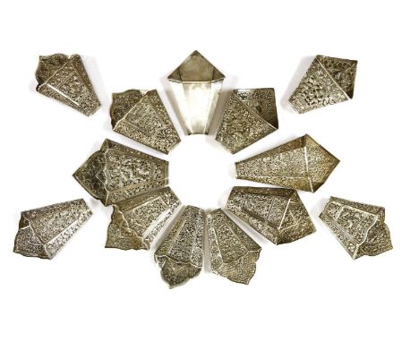 A collection of thirteen Chinese silver sirih leaf holders,c.1900, one plain, one cast with chrysanthemums between prunus and