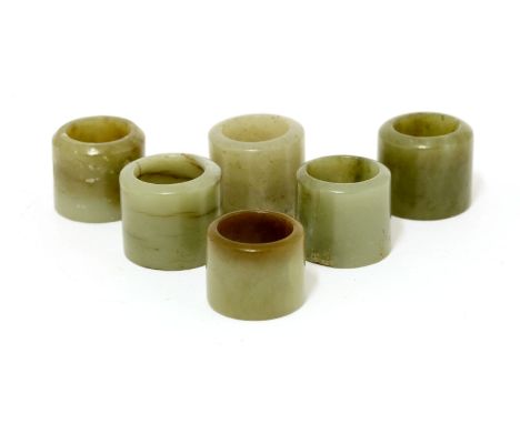 A collection of six Chinese jade archer's rings, Qing dynasty (1644-1911), of cylindrical form, plain, 2.2 to 2.6cm high (6)