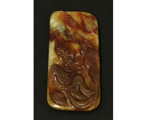 A Chinese jade plaque, Qing dynasty (1644-1911), of rectangular form, one side carved with a dragon and a phoenix, the revers
