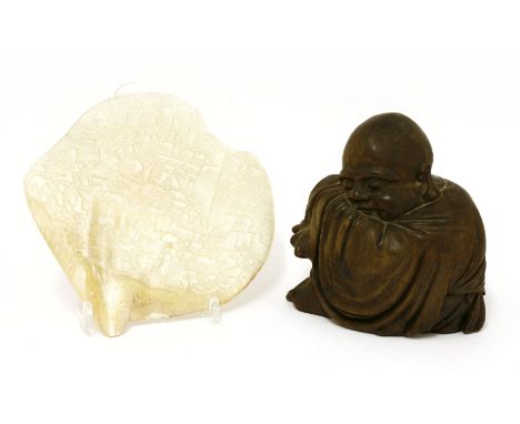 A Canton carved clamshell, 19th century, with a battle scene outside a city gate, 20.2cm wide, and a Japanese wooden figure o