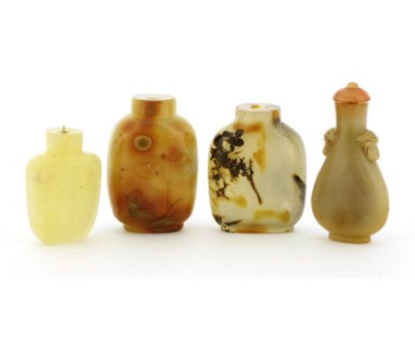 A group of three Chinese agate snuff bottles, 19th century, one plain, one carved with carp under a lotus leaf, one in pear s