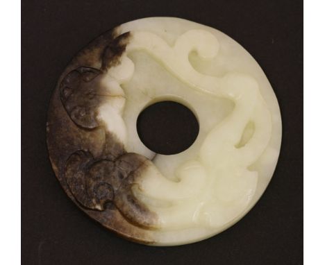 A Chinese jade bi disc,Ming dynasty (1368-1644), of circular form carved with a chilong, the underside with archaic studs,6.5
