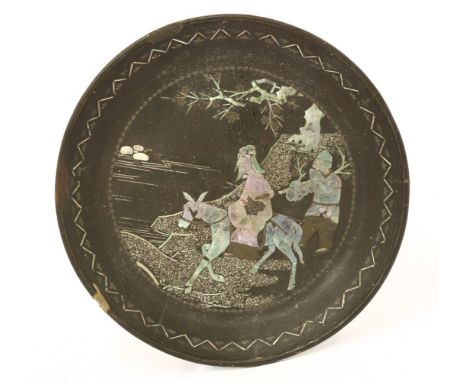 A Chinese lac burgauté dish,Kangxi (1662-1722), onlaid in mother-of-pearl with a scholar riding a donkey in a landscape, foll