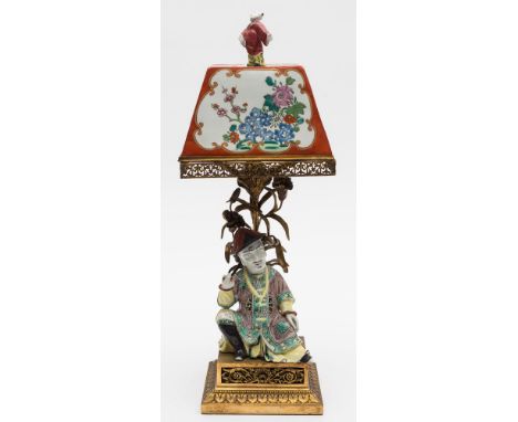 A French porcelain and ormolu 'chinoiserie' table lamp: the square section shade with figure finial and painted with baskets 