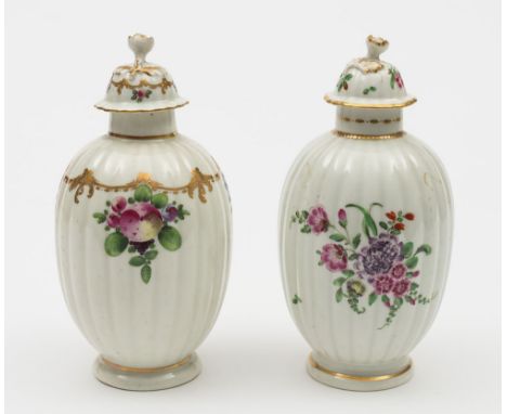 Two Worcester tea canisters and covers: each of reeded ovoid form with flower finials, one painted with bunches of spotted fr