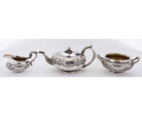 A William IV silver three-piece tea service, maker Robert Hennell II, London, 1931: crested, of circular form with banded flo