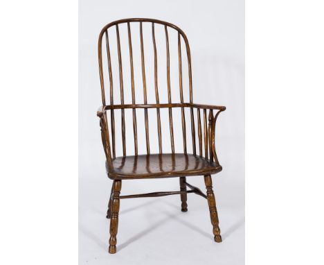 A late 18th/early 19th Century ash and elm stick back Windsor elbow chair:, with shaped arm supports and shaped solid seat on