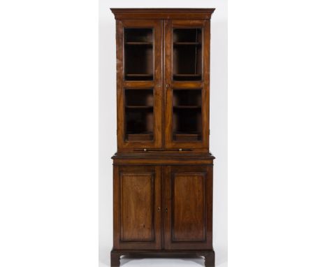 An 18th Century and later 'red walnut' bookcase:, of small size, the upper part with a moulded cornice, fitted with adjustabl