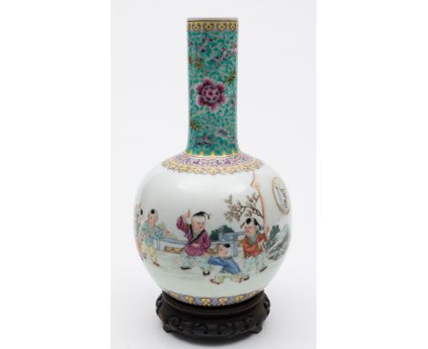 A Chinese porcelain bottle vase: enamelled in the famille rose palette with four children playing in a garden, with a poetic 