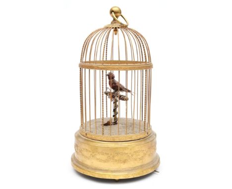 A French clockwork automaton singing bird in cage: the clockwork operated feathered bird on a floral decorated perch containe