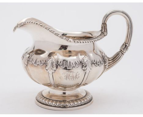 A George IV silver cream jug, maker Paul Storr, London, 1823: crested, monogrammed and inscribed to the underside of the base