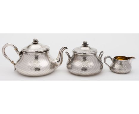 A Continental three-piece silver tea service, retailed by Attcoc Aine, marked to the base: initialled, of circular form with 