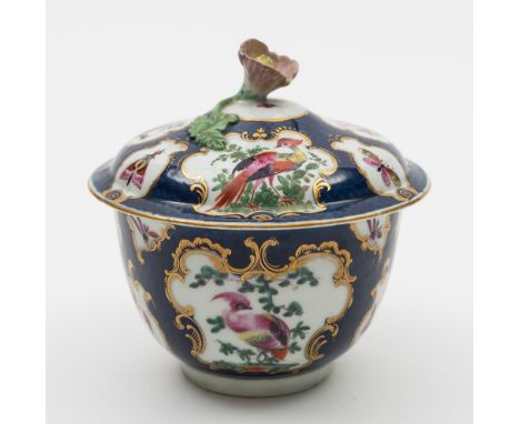 A Worcester scale blue sucrier and cover: with flower finial, painted with gilt bordered cartouches of exotic birds and insec