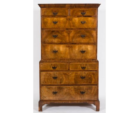 An early 18th Century walnut veneer fronted chest on chest:, with stained pine sides, the upper part with a moulded cornice, 