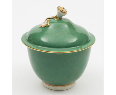 A Worcester solid apple green ground sucrier and cover: the domed cover with gilded flower and leaf finial, a gilt floral spr