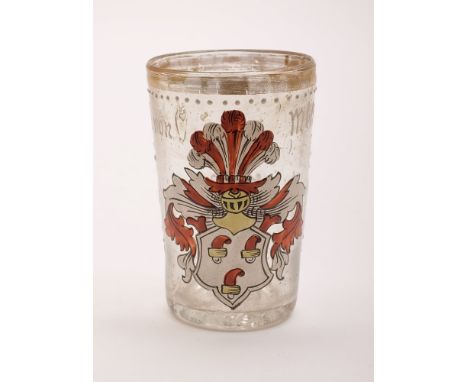 A German enamelled glass armorial tumbler, dated 1594: with gilt rim, inscribed in white 'Ernst von Mestzing 1594' around a r