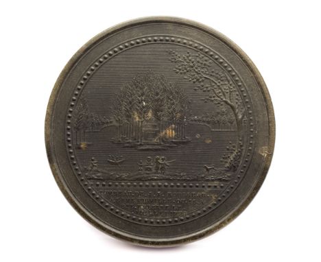 A late 18th Century French tortoiseshell snuff box: the circular top decorated with a view of Rousseau's tomb, 8cm. diameter.