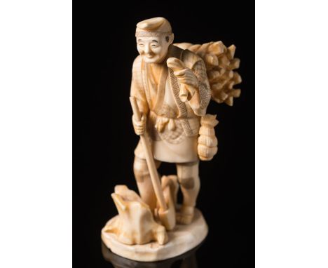 A Japanese carved ivory okimono of a woodsman: Meiji period (1864-1912), holding an axe in one hand and a bundle of kindling 