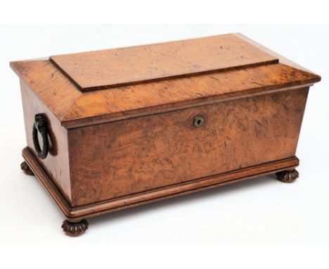 A Victorian burr walnut tea caddy: of sarcophagus outline, with shallow domed hinged lid enclosing a central well with associ