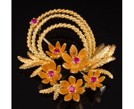A ruby mounted floral spray brooch: set with six circular rubies, stamped '18k', 13gms gross weight. 