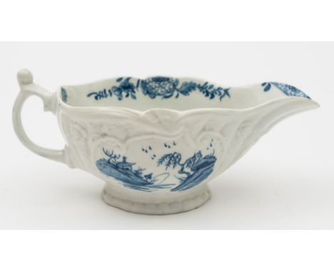 A Worcester blue and white sauceboat: of silver shape with scroll handle and thumbrest, moulded with strap fluting, foliate s