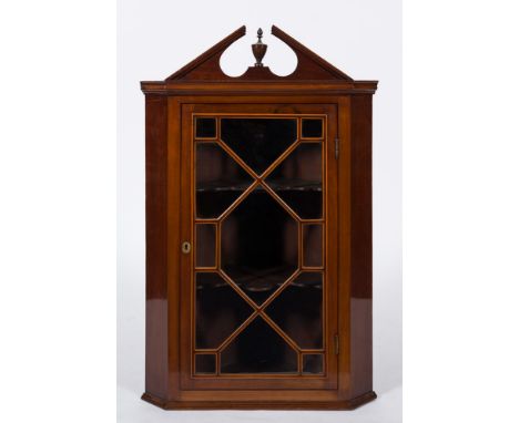 A 19th Century mahogany and inlaid hanging corner display cabinet:, with an architectural moulded broken pediment centred by 