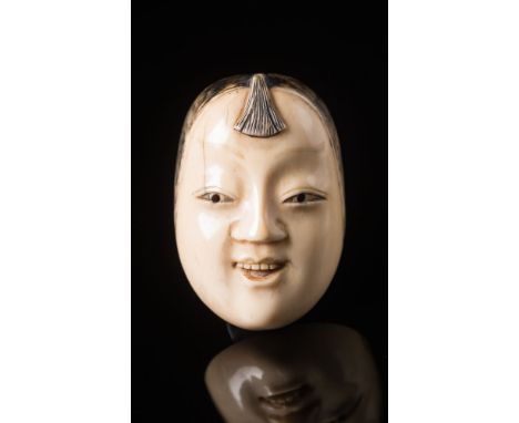 A Japanese carved ivory netsuke: Meiji period (1864-1912) of Mambi's mask (see Davey p.368, No 1106), signed Shunko, 4.5cm. h