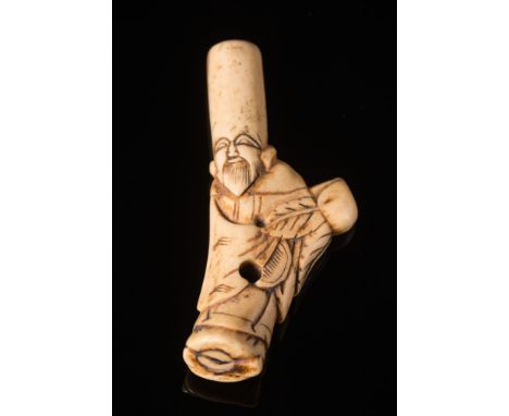 A Japanese stag horn netsuke: Meiji period (1864-1912) in the form of an Immortal, unsigned 8cm. high.