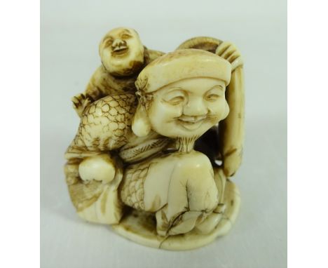 Meiji period ivory Netsuke of a man carrying child and another at his feet, with signature on base, H4cm    Condition Report 