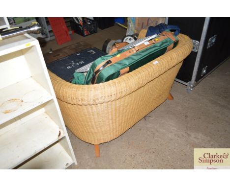 A cane two seater sofa lacking cushions 