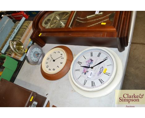 Two wall clocks; an alarm clock and one other